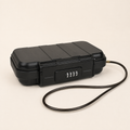 Black portable travel safe with four-digit combination lock and integrated security cable